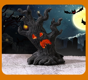 Detailed view of resin Halloween tree monster with glowing orange fire eyes and wood texture