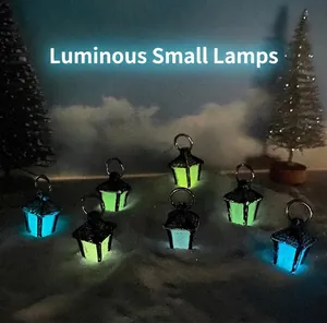 Luminous miniature lanterns showing blue and yellow-green glowing effects in a snowy scene