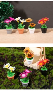 Macro detail of miniature dollhouse sunflowers in colorful pots for garden scenery