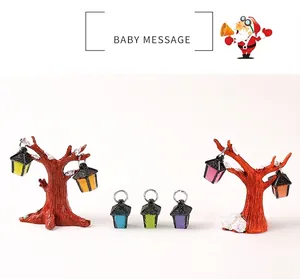 Miniature colorful resin lanterns and snow-covered trees for Christmas micro landscape decor