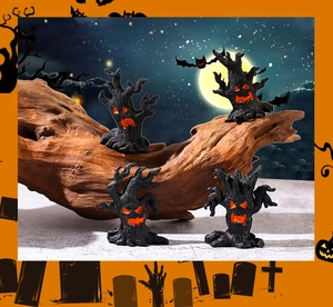 Macro detail of four Halloween tree monster miniatures with glowing orange faces