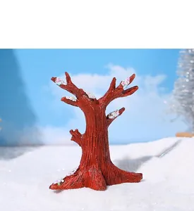 Close-up of resin winter tree miniature with colorful glitter and snow texture