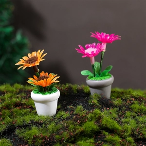 Miniature sunflower and daisy potted plants on green moss for dollhouse decor