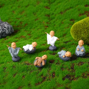 Detailed macro view of 6 miniature resin monk figurines for moss succulent micro landscapes