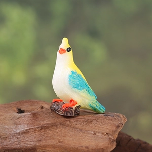 Miniature resin blue and white parrot figurine on wood base for garden decor