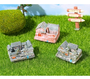 Detailed trio of miniature Chinese courtyard house models on artificial green grass