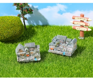Detail of miniature Chinese courtyard house model with grey tiles and red door banners