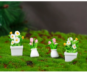 Macro shot of miniature dollhouse daisy and tulip resin plants in white pots