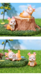 Detail view of miniature resin deer figurines in different playful poses for garden decor