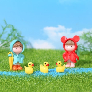 Miniature micro landscape figurines set with couple in raincoats and yellow ducks