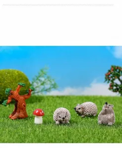 Detailed view of miniature resin hedgehogs with tiny mushrooms and tree trunk models