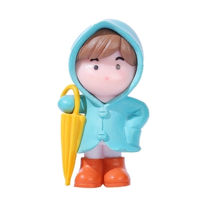 Miniature figurine in blue raincoat holding a yellow umbrella for garden decor