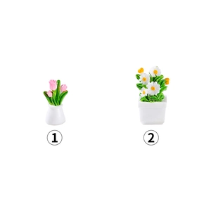 Miniature dollhouse potted plants with pink tulips and white daisies in white ceramic pots