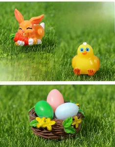 Miniature Easter figurines set with bunny, chick, nest and colorful eggs on grass
