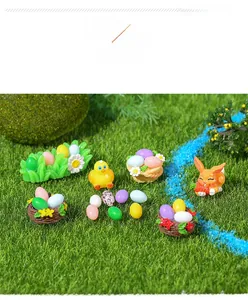 Miniature resin Easter figurines set with colorful eggs and rabbits on green grass