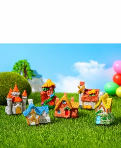 Close-up of resin miniature houses including castles and cottages for fairy garden decor