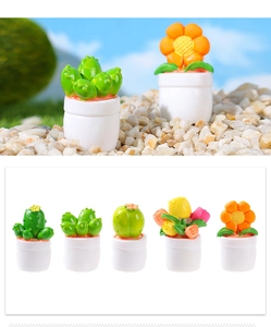 Macro detail of miniature resin cactus and tulip plants in white pots for dollhouses