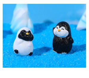 Close-up of cute resin penguin figurines for miniature landscape or bonsai decor