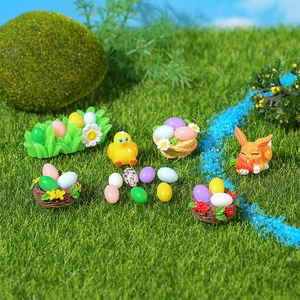Resid Easter miniature set with rabbit, colorful eggs and chicks in a garden scene