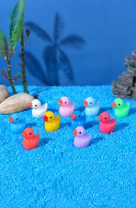 Macro shot of colorful miniature resin ducks set in a creative moss micro landscape