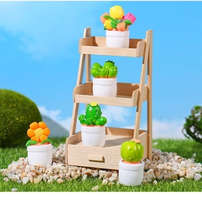 Miniature dollhouse cactus plants in white pots on a three-tier wooden display stand