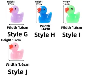 Detail view of miniature resin ducks in four colors with 1.7x1.6cm dimensions