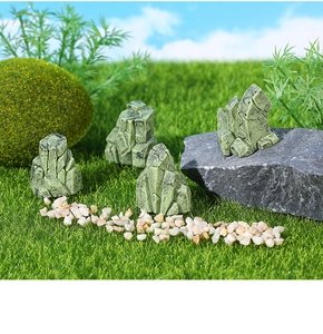Detailed view of four miniature moss-covered rocks for aquarium and garden landscape