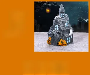 Detailed view of miniature Halloween haunted house with pumpkin lanterns and ghost details
