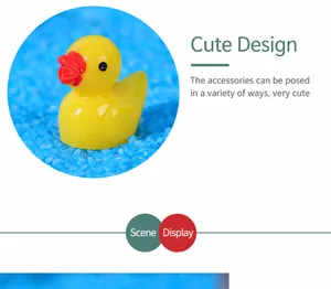 Close-up of yellow resin duck figurine on blue decorative sand for micro landscapes