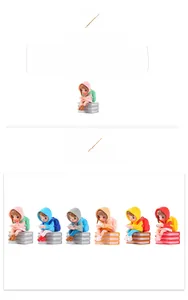Detail of miniature PVC figurines featuring girls in raincoats reading on books