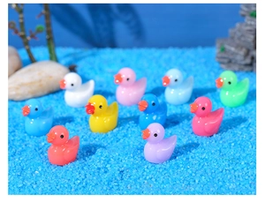 Close-up of colorful resin ducks in various vibrant colors for DIY miniature landscape decor