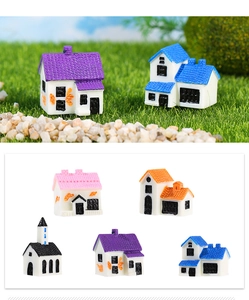 Detailed macro view of five miniature resin house styles for DIY terrarium landscaping