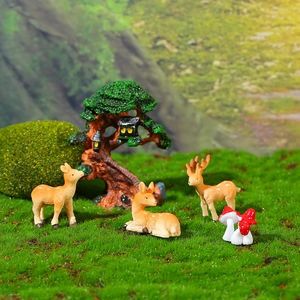 Miniature woodland set with resin deer figurines, mushrooms, and a detailed fairy tree house