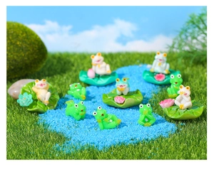 Close-up of assorted resin frog figurines on lotus leaves for micro landscape decor