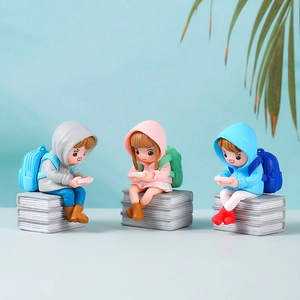 Three creative PVC cartoon figurines playing games on book bases for home decor