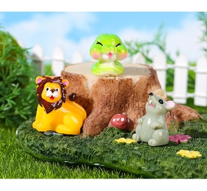 Detalle de figuras de resina de león serpiente y ratón en un micro paisaje de jardín
