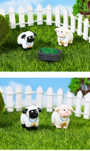Close-up of cute resin sheep figurines with wool texture and a green manger for micro landscape