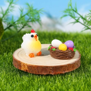 Miniature resin chicken figurine and colorful egg nest on wood for DIY garden decor
