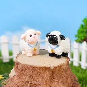 Miniature resin sheep figurines set with bells and blue ribbons for garden decor