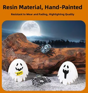 Detail of hand-painted resin ghost and spider miniatures for Halloween decor