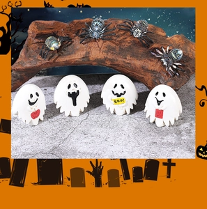 Detail of Halloween resin miniature set featuring white ghosts and colorful spiders