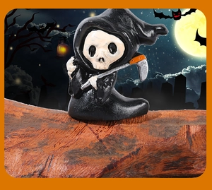 Cute miniature Halloween grim reaper figurine with skull face and scythe on wooden base