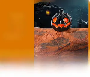 Close-up of a glossy black Jack-o'-lantern ornament with bright orange facial features