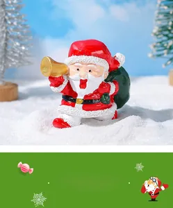 Miniatura di Babbo Natale in resina con tromba dorata e sacco dei regali verde