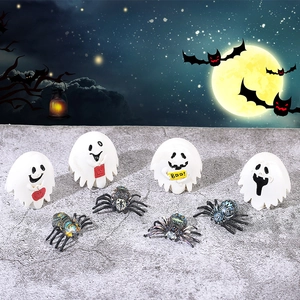 Halloween miniature ghost and spider set on stone surface with a spooky night background