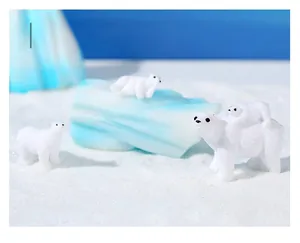 Miniature polar bear family figurines on snowy landscape for micro landscape decor