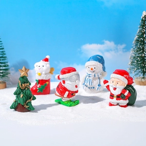 Set di figurine natalizie in miniatura con Babbo Natale e pupazzo di neve sulla neve