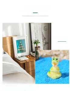 Macro shot of cute resin crocodile figurine on blue sand for aquarium or home decor