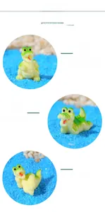 Detail showing various poses of mini resin cartoon crocodiles on blue sand substrate