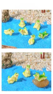 Close-up of miniature cartoon resin crocodiles in a beach micro-landscape scene